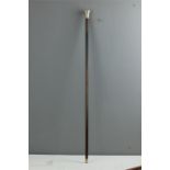 A walking cane with silver top, engraved with decoration.