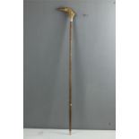 A walking cane with painted greyhound head handle and silver metal ferule.