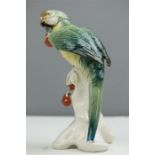 A Karl Ens porcelain parrot with cherries, 24cm high.