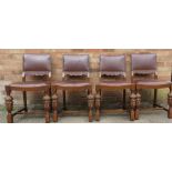 A set of four oak chairs with leather backs and seats and cup & cover legs carved with flowers.