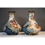 A pair of oriental hand baluster vases with vibrant colouring and gilded highlights.