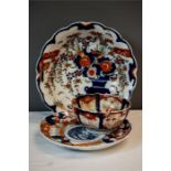 Two Imari plates and an Imari bowl. (3)