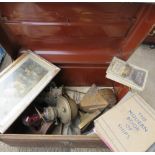 A tin trunk containing various items including lantern.