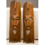 A pair of 1950s African tribal carved masks.