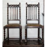 A pair of oak hall chairs together with an occasional table with barleytwist legs.