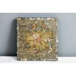A late 19th/early 20th century tile depicting snakes and cherubs, composed of specimen marble, agate
