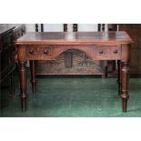 A 19th century green leather top writing table, with rounded corners, with a drawer front and boldly