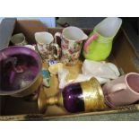 A group of ceramic jugs; various makers, and a pair of purple glass vases.