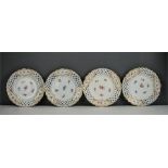 A set of four 20th century Meissen plates, hand painted with flowers and pierced with a pierced