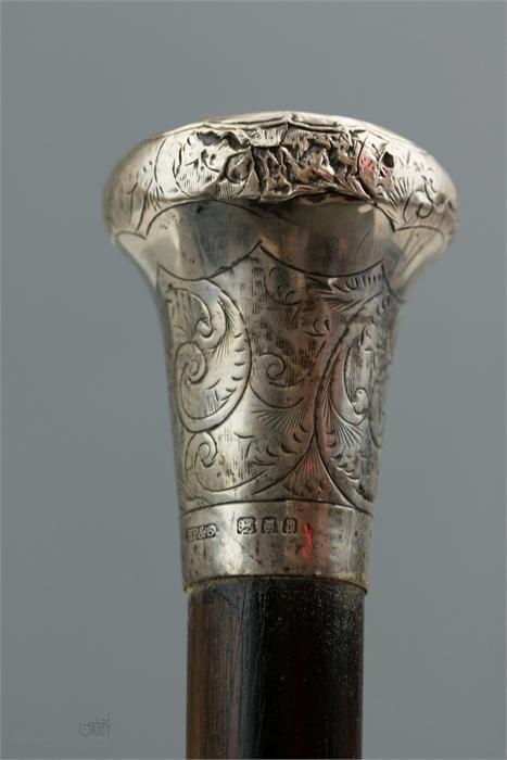 A walking cane with silver top, engraved with decoration. - Image 2 of 2