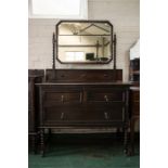 An oak dressing table with rectangular mirror back and carved ropetwist detail.