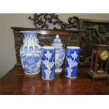A group of blue and white ceramics including a jar and cover, a pair of vases depicting prunus