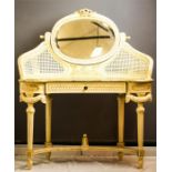 A French Bergere style dressing table with oval mirrored back, painted cream and carved with