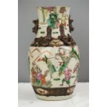 An early 20th century Chinese vase with raised salamanders and enamelled figures.