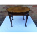 A mahogany coffee table with cabriole legs.