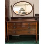 An Edwardian mahogany dressing table with an oval mirrored back and two short over two long drawers.