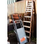 A pair of folding steps and a folding wooden stepladder.