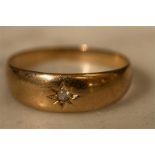 A gold ring, worn hallmarks, with starbust centred by a chip diamond, size P, 3.5g,