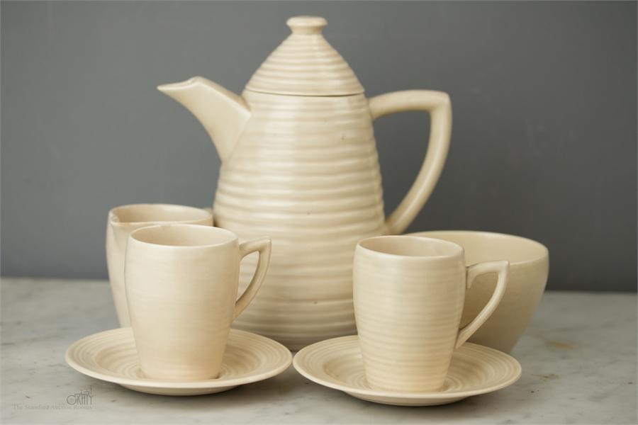 A Clarice Cliffe coffee set in the spiral ware des