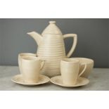 A Clarice Cliffe coffee set in the spiral ware des