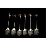 A matched set of six silver spoons with dog head finials, traces of residual gilding, all Birmingham