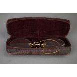 A pair of pince nez Edwardian spectacles in a case marked J.S. Prior, Optician of Stamford.