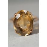 A 9ct gold and citrine ring, the oval citrine in a pierced setting, size M, 4.5g.