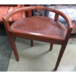 An oak demi-lune form chair with cane work seat.