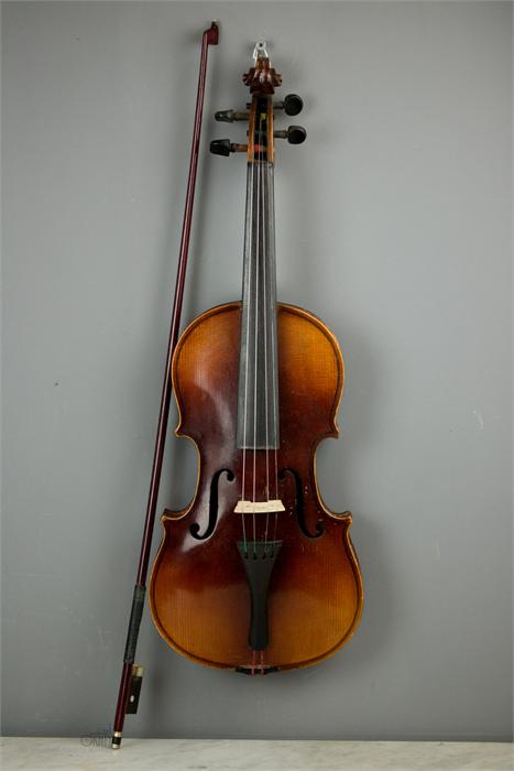 A full size violin bearing label inside, with bow and case.