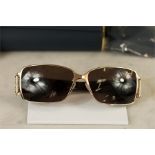 A pair of Chopard sunglasses with gold coloured fr