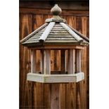 An octagonal top bird feeder.