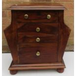 A teak bedside cabinet with drawers and magazine r