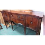 A mahogany Sheraton style serpentine sideboard wit