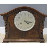 An oak cased 1930s mantle clock with barleytwist columns.