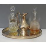 A silver plated claret jug, two cut glass decanters with drink tags, together with an oval tray.