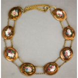 A goldstone and micro-mosaic necklace composed of eight oval segments inlaid with mosaic floral