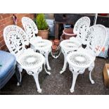 A set of four white painted metal garden chairs.