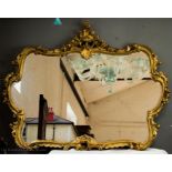 A giltwood wall mirror with Rococo style scrollwor