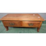 A mahogany table cabinet with two drawers, raised on bracket legs.