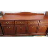 A mahogany sideboard with four cupboard doors encl