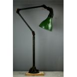 A retro industrial angle adjustable lamp, painted green.