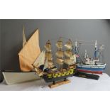 Three model boats together with nautical themed items, ships wheel clock, table lamp, a miniature