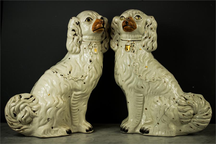 A pair of Staffordshire dogs, with painted detail.