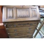 An oak bookcase with linenfold carved cupboard doo