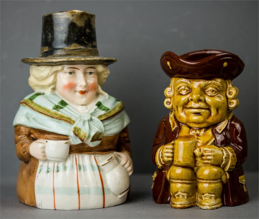 An antique porcelain Welsh Toby jug; woman in traditional Welsh attire, together with a Dartmouth