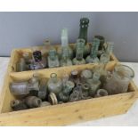 A large quantity of excavated glass bottles of various size and form, many named.