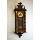 A large 19th century mahogany Vienna wall clock, the eagle carved surmount, with turned split carved