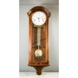 A Comiti wall clock with mahogany case and brass pendulum.