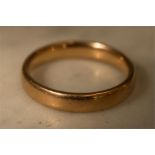 A gold wedding band, worn hallmarks, size Q, 5.4g.