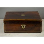 A 19th century rosewood writing box, the shaped brass plaque inlaid to the top with boxwood